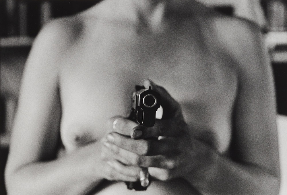 Naked woman with gun