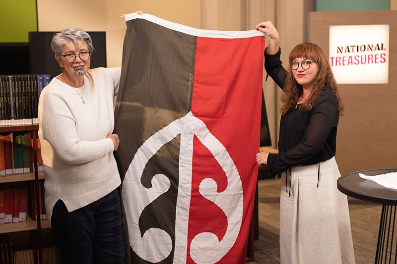 Two women holding up a flag
