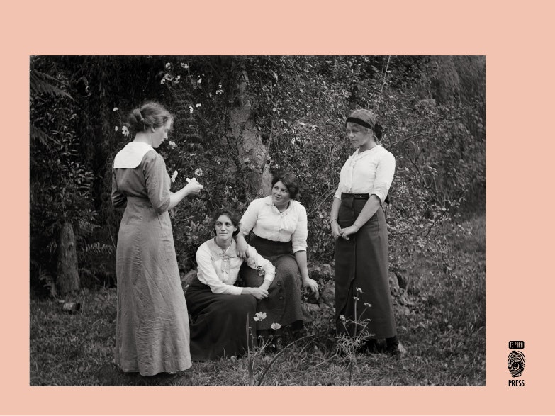 black and white photograph of four women in a garden