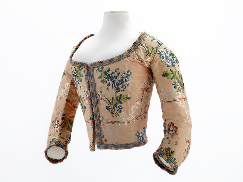 Woman's bodice, 1730-1750, France, maker unknown. Bequest of Mrs Alec Tweedie, 1946. CC BY-NC-ND 4.0. Te Papa (PC000044) An embroidered bodice of an 1730s garment on a white background