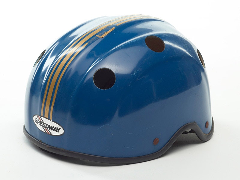 Helmet, circa 1981, New Zealand, by Speedway. Gift of John Minto, 2008. CC BY-NC-ND 4.0. Te Papa (GH012029) A blue helmet with gold stripes