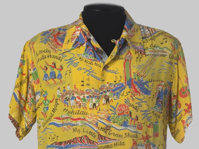 Aloha shirt by Malihini featuring Hawaiian mele (songs), c. 1950. This shirt belonged to Tommy Holmes. Te Papa Yellow aloha shirt
