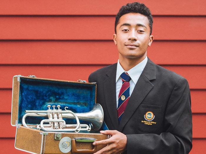Samiuela Paea. Photograph by Amanda Rogers. Te Papa A student stand with a trumpet in a box