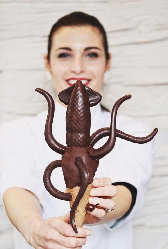 Woman holds an ice cream shaped like a squid
