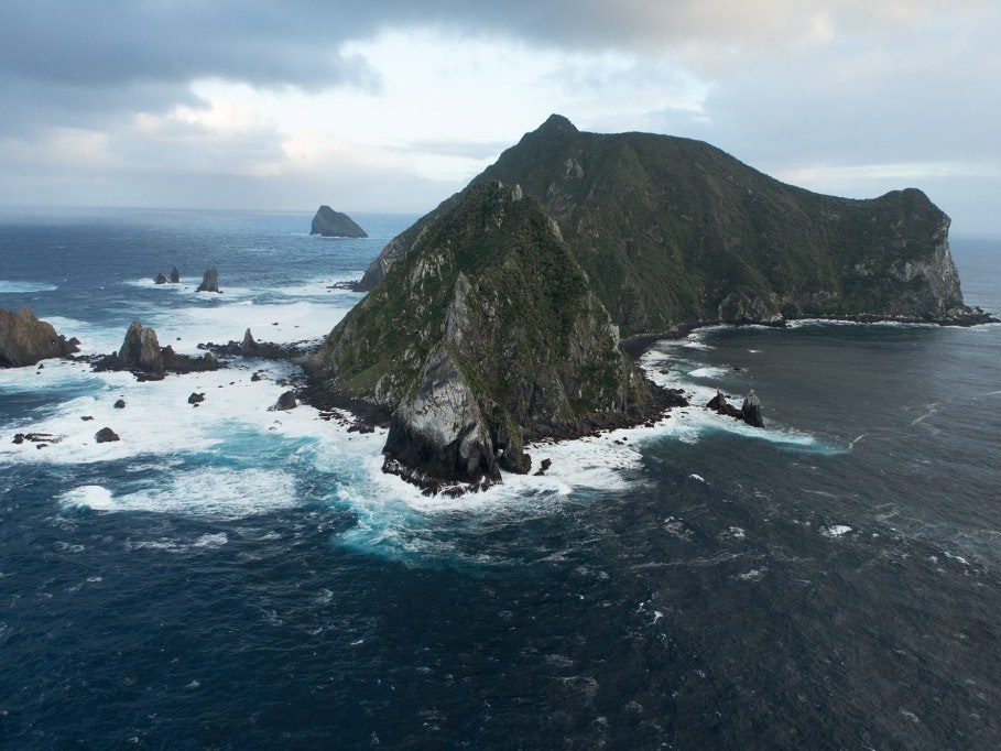 The steep cliffs of Solander Island loom out of the mist like a lost world, 2013. Photograph by Michael Hall. Te Papa solander-island-te-papa.jpg