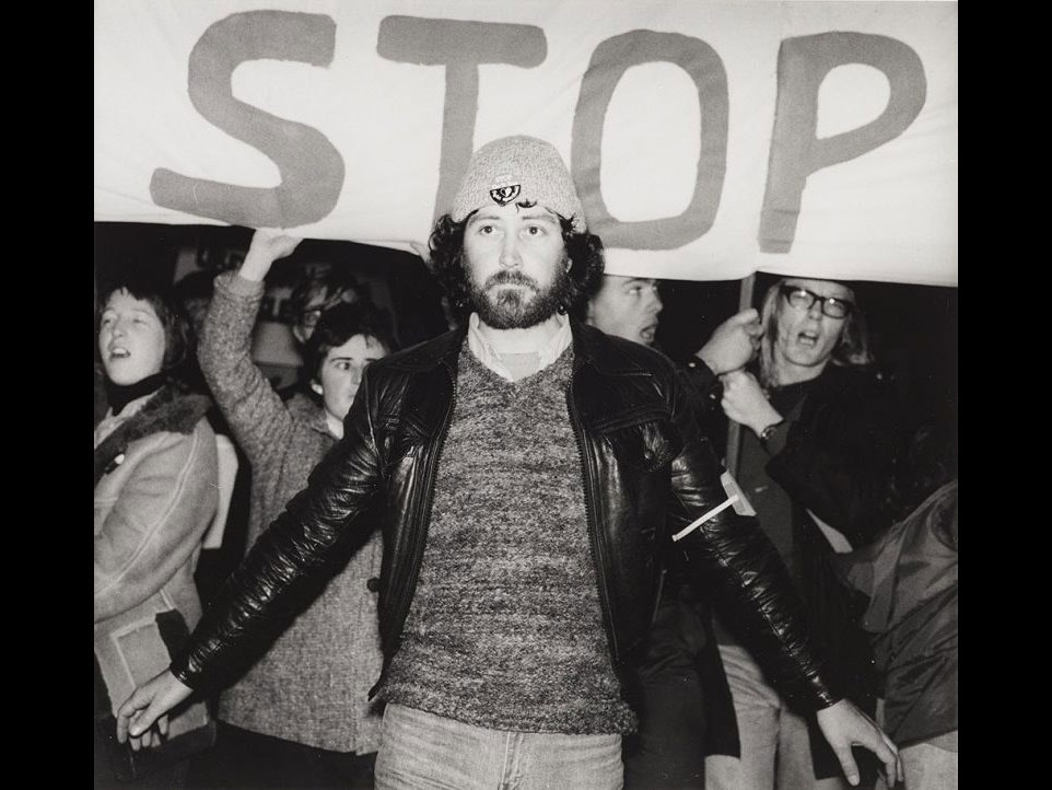 Chris McBride during an anti-Springbok rugby tour demonstration, 1981. Ans Westra, Anti Springbok tour demonstration, 1981, gelatin silver work-print. Te Papa (O.012072) A man stands in front of a sign which says 'stop'