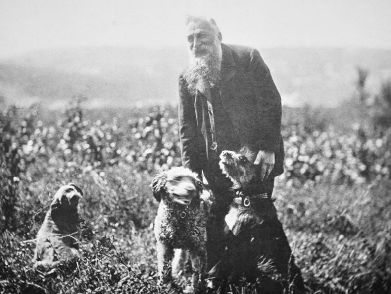 Auguste Rodin and his dogs, Meudon, c. 1910. Public domain Auguste Rodin surrounded by three dogs