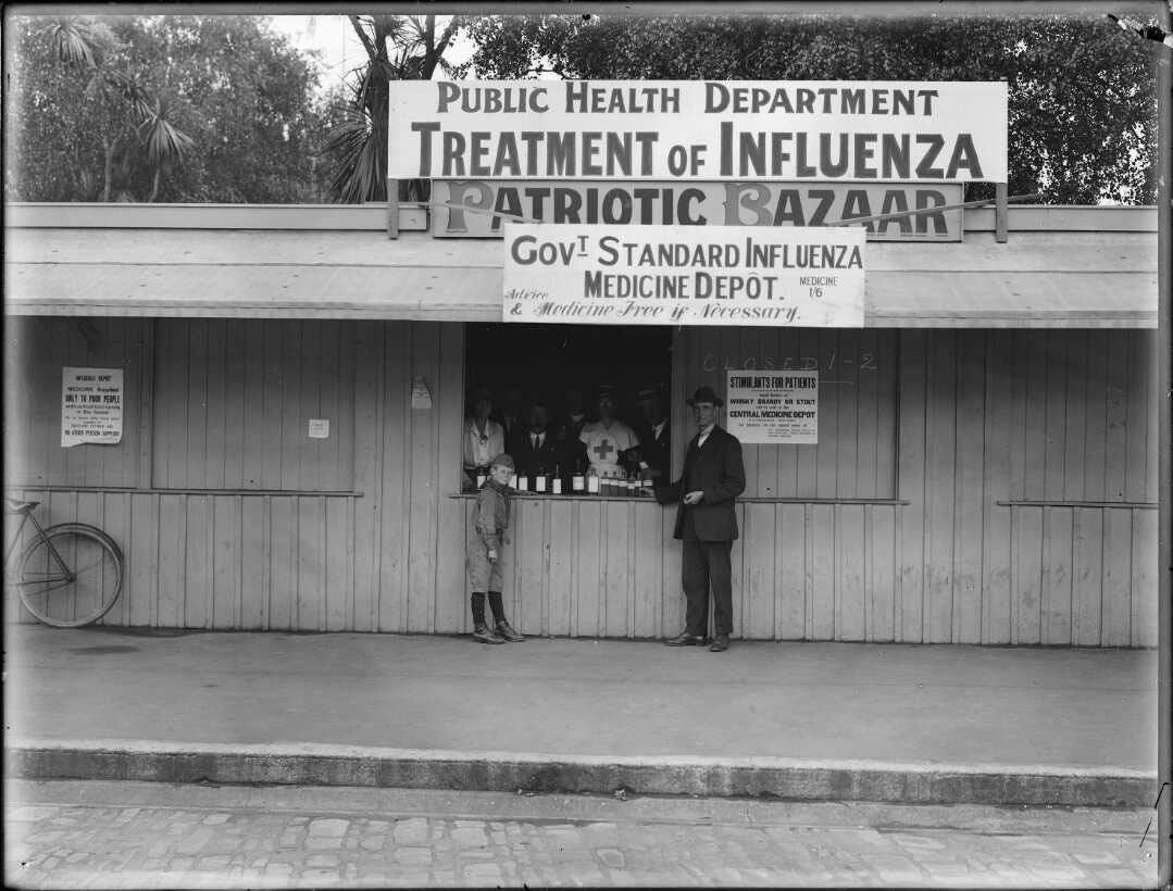 An influenza medicine depot a man and a boy stand outside