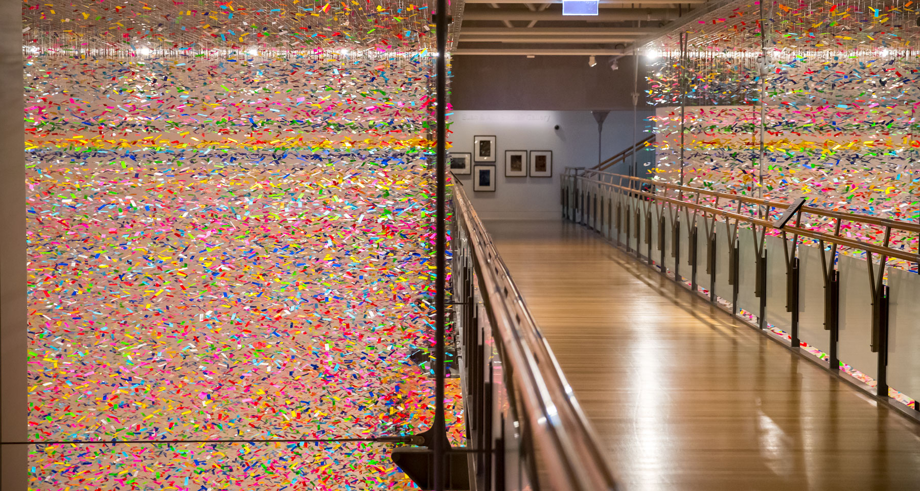 Installation shot of the colourful artwork which looks like confetti filling the whole gallery space