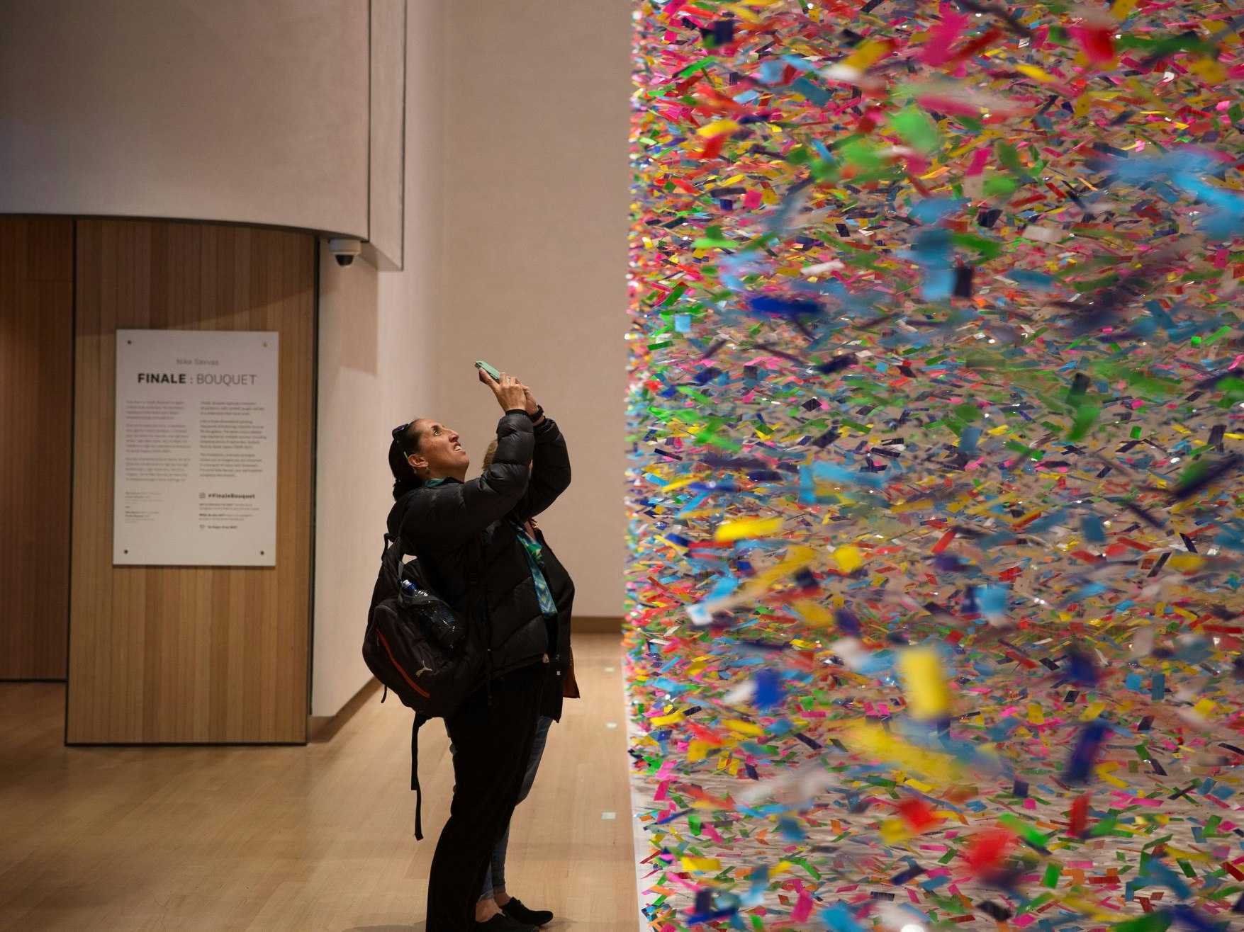 A visitor trying to capture the scale of Finale: Bouquet, 2019. Photo by Jack Fisher. Te Papa A visitor trying to capture the scale of a colourful artwork