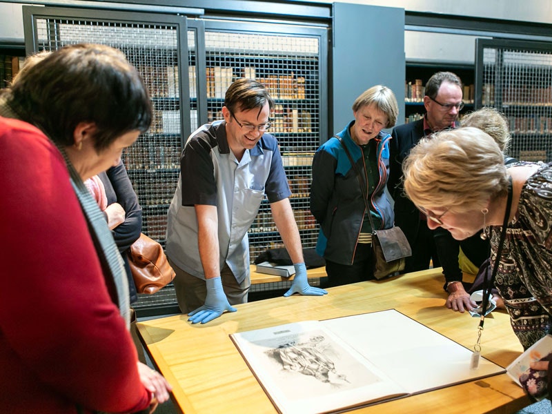 Tour of the library, 2019. Te Papa People looking at rare books