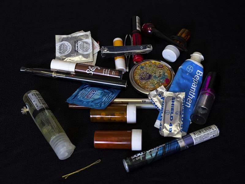 Contents of makeup bag, 2019. Photo by Daniel Crichton-Rouse. Te Papa An array of items, including lubricant, condoms, lipstick nail clippers, pills, a hairclip, an other  things