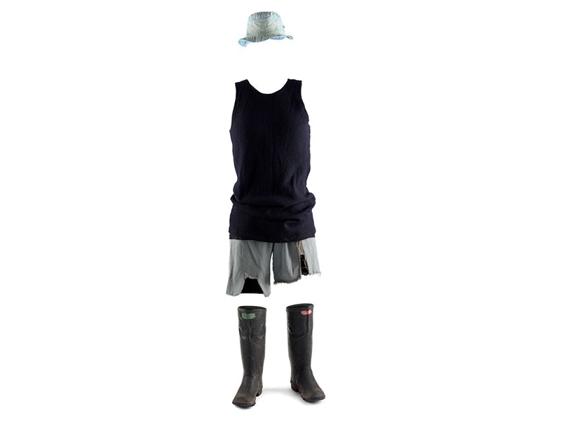 Fred Dagg's singlet, manufactured by Mosgiel Woollen Factory Company (Limited), 1973. Gift of John Clarke, 2002. Te Papa (GH014302) Gumboots, shorts, a singlet and a hat set up like there is a person wearing them on a white background