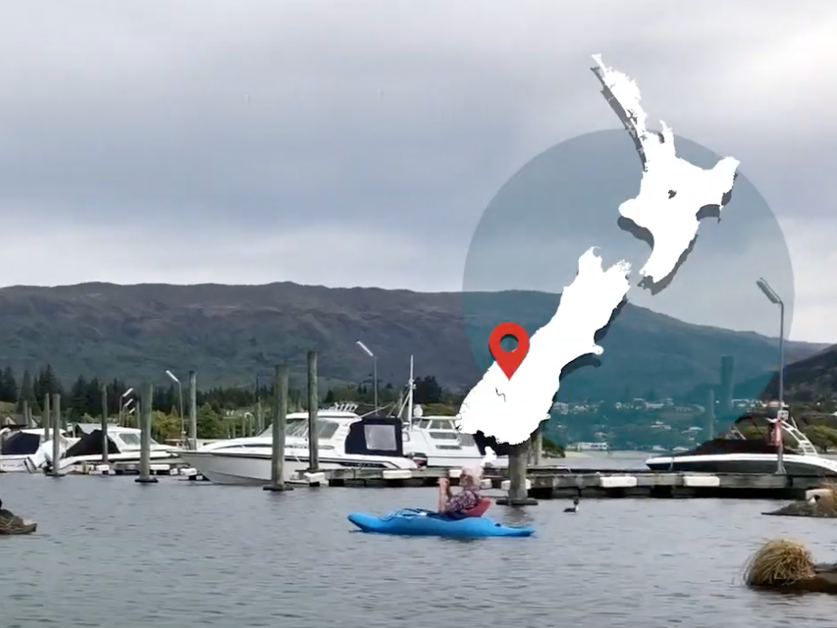 Still from Helping lake birds breed, Lake Wānaka. Te Papa People in boats on a lake with a map of New Zealand overlaid on the right-hand side
