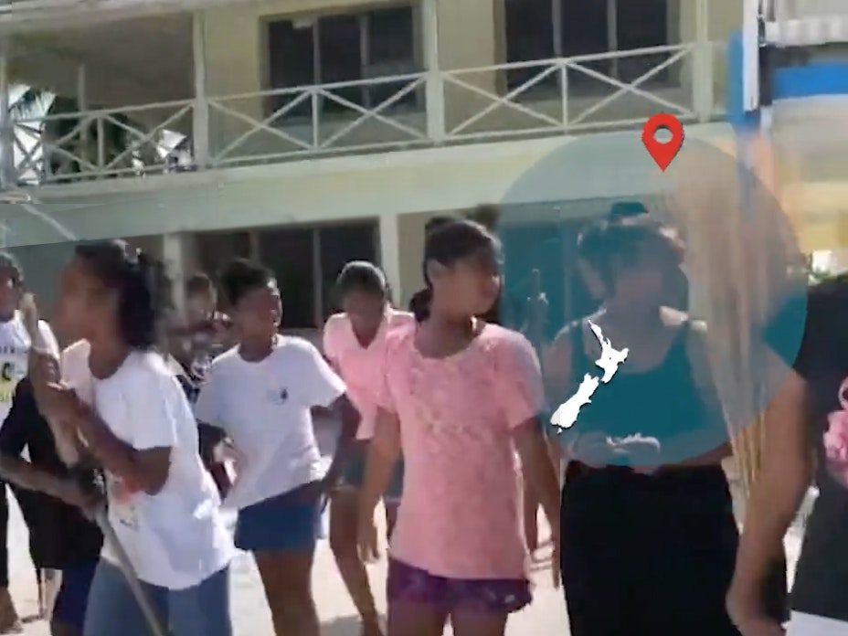Video still from Tree planting, Tokelau Children walking away from a building with a map overlaid in the top right corner