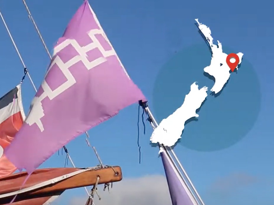 The mast of a boat with sails and map overlaid with a map of New Zealand on the top-right