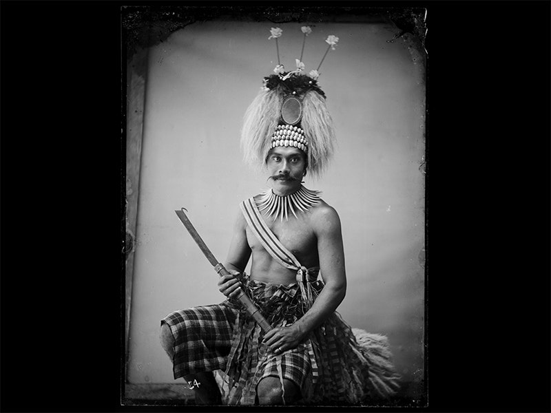 Talolo, 1890-1894, Sāmoa, by Thomas Andrew. Te Papa (C.001558) An old black and white photo of a Sāmoan chief in a headdress