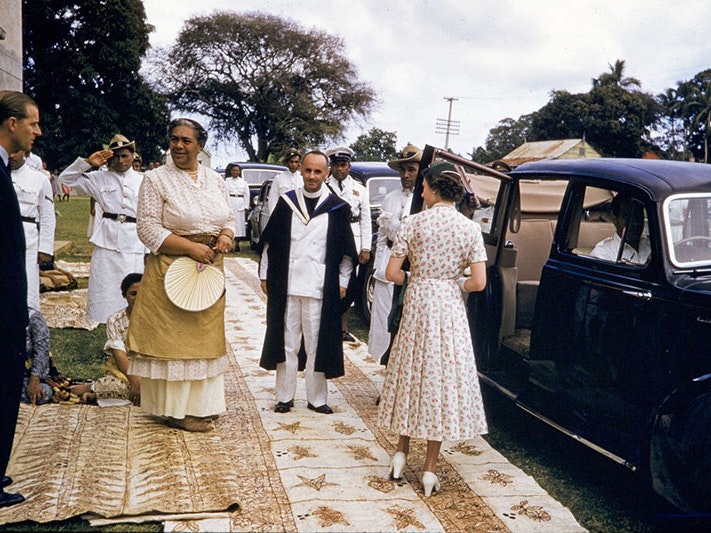 The Duke of Edinburgh, Queen Sālote Tupou III and Queen Elizabeth II, Royal Tour, Tonga, 1953, by Brian Brake. Gift of Wai-man Lau, 2001. Te Papa (CT.045197) Duke of Edinburgh, Queen Sālote Tupou III and Queen Elizabeth II stand outside a car, standing on tapa, in preparation of getting into the car