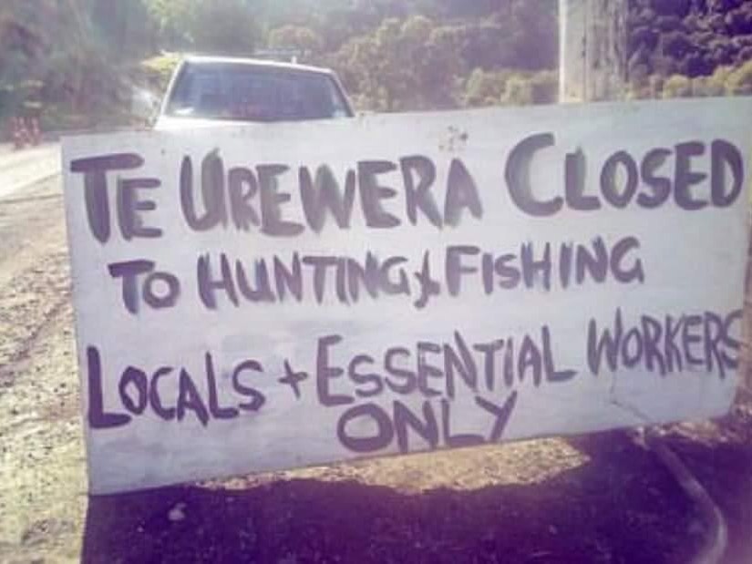 Te Urewera checkpoint. Photo courtesy of Kate Hudspith-Gooch A handpainted sign on the side of the road with the words 'Te Urewera Closed to hunting and fishing. Locals and essential workers only'"
