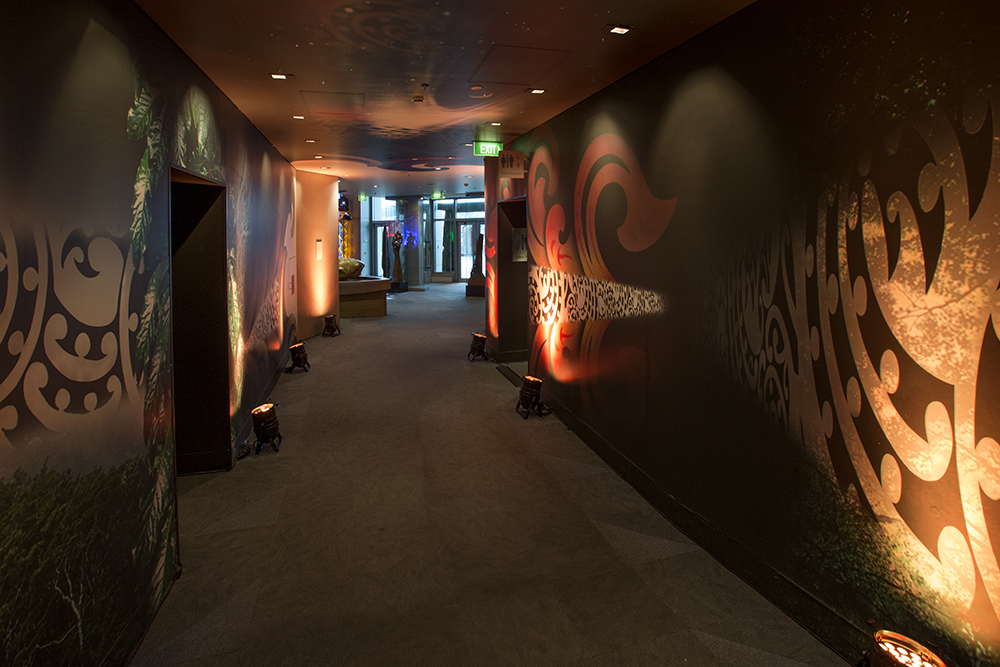 A dark passageway with colouried graphics lining the walls.