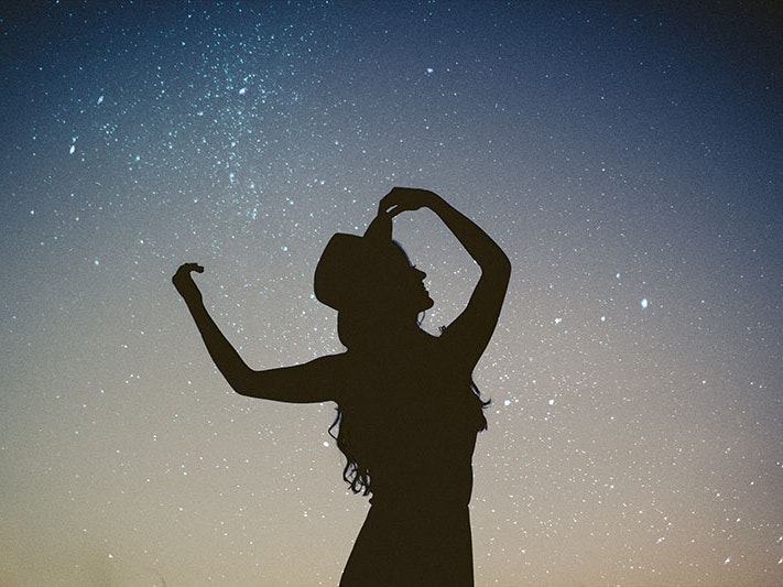 “I call it magic, when I’m with you”, 2017. Photo by Allef Vinicius / Unsplash Silhouette of a woman holding her brimmed hat on her head, with the stars in the sky behind her