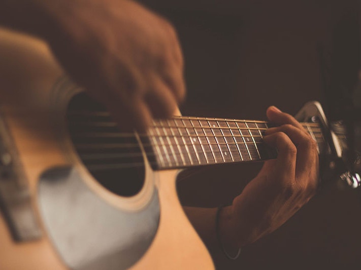 Person playing guitar, 2017. Photo by Jefferson Santos / Unsplash Close up of a person playing the guitar