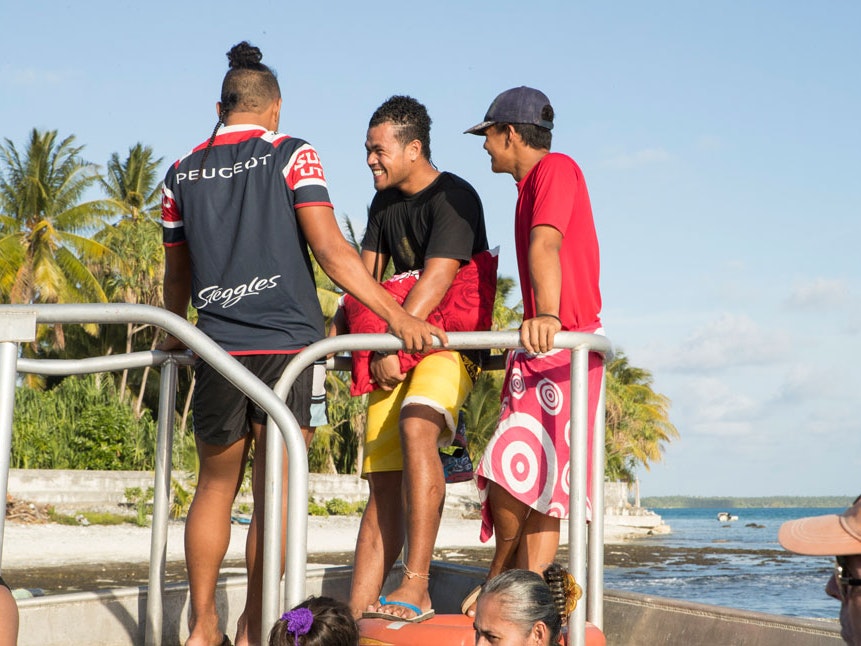 Teenagers on board the cargo vessel, Atafu, Tokelau, 2017. Photo by Kate Whitley. Te Papa (100218) Teenagers on a boat, blue clear water below them