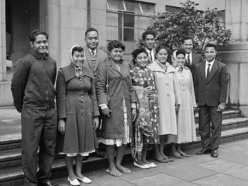 Tokelauan group who came to live in Wellington. Dominion post (Newspaper): Photographic negatives and prints of the Evening Post and Dominion newspapers. Ref: EP/1964/1760-F. Alexander Turnbull Library, Wellington, New Zealand. /records/23223266 A black and white photo of a group of adults standing on some steps smiling