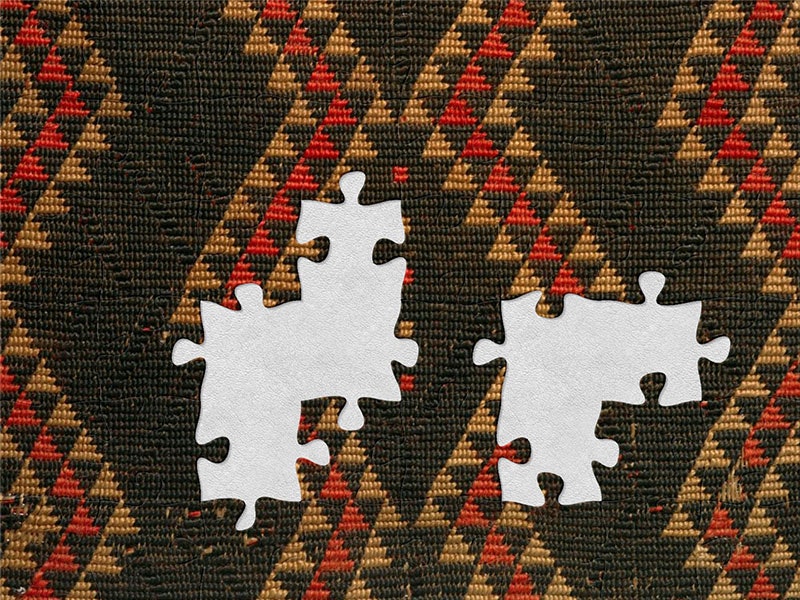 Detail of kaitaka paepaeroa with ngore (cloak with taaniko borders and vertical aho, weft rows), date unknown, maker unknown. Te Papa (ME015672) Close up of a cloak, showing the detail of its design. It is predominantly black with red and earth coloured triangles forming a wave across the cloak