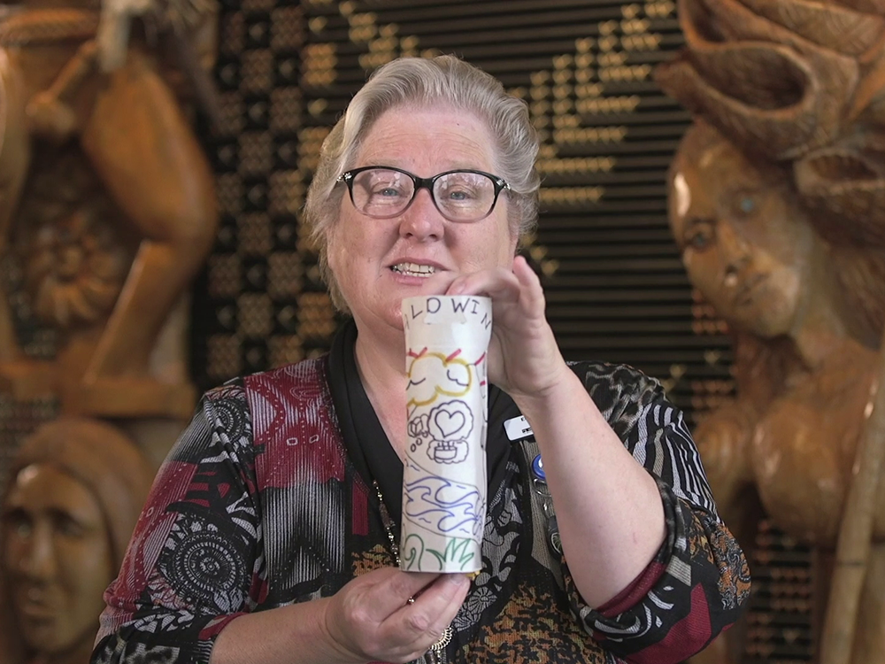 Still from Raranga Matahiko 2a and 2b. Te Papa A woman holding an object