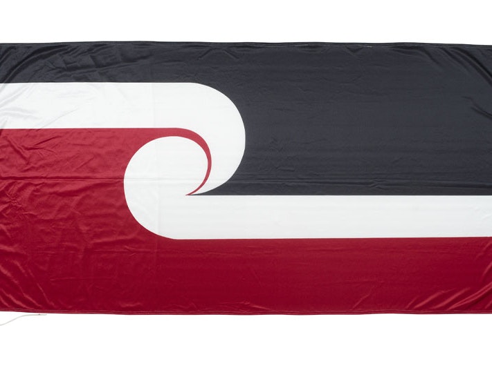 Tino rangatiratanga flag, 1998, Te Kawariki Group, Wellington, nylon. Te Papa (ME017396) Tino rangatiratanga flag: top third is black, bottom third is red, middle third, in the shop of two koru, is white