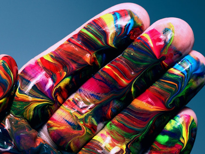 Multicoloured hand paint, 2018. Photo by Alexander Grey / Unsplash Close-up photo of a hand with multicoloured paints smeared across it
