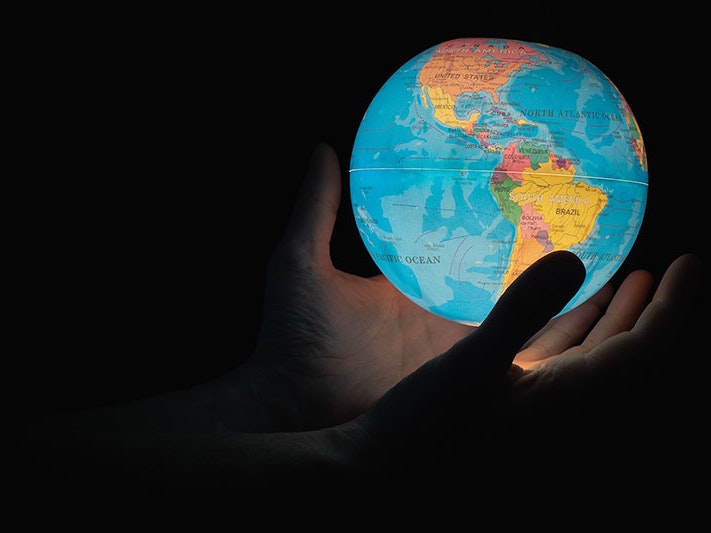Lit up globe, 2020. Photo by Greg Rosenke / Unsplash Photo of hands holding a small globe which is illuminated from the inside