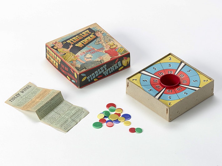 Tiddley Winks, Codeg; manufacturer(s); about 1970s; England. Gift of Jennifer Timmings, 2014. Te Papa (GH024318) A game of tiddley winks with the box open and the pieces next to the box.
