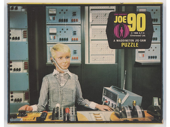 Jigsaw puzzle, Joe 90, Waddingtons; creating agency; 1960s. Purchased 2020. Used with permission. Te Papa (GH025914) A photo of the top of a jigsaw puzzle box with an image from the TV series Joe 90 on it.