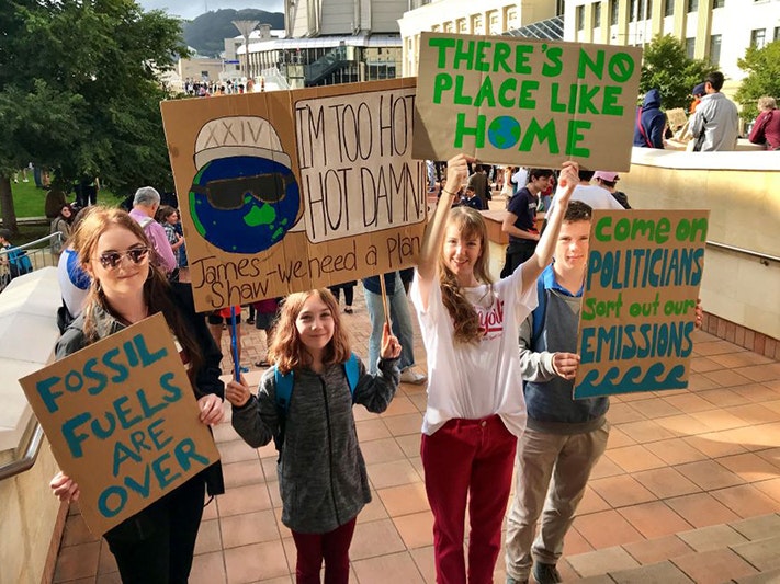 Students with their School Strike for Climate Action placards, Wellington. Photo by Raewyn Humphries; photographer; 15 March 2019; New Zealand. Gift of Raewyn Humphries, 2019. Te Papa (O.048375) Four school children holding protest signs outside in a public square.