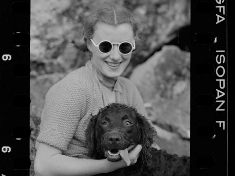 Portraits and country scenes, Waipukurau, September 1940, Hawke's Bay, by Eric Lee-Johnson. Te Papa (E.001670) A woman with a dog. The dog's eyes are crossed and his tongue is out