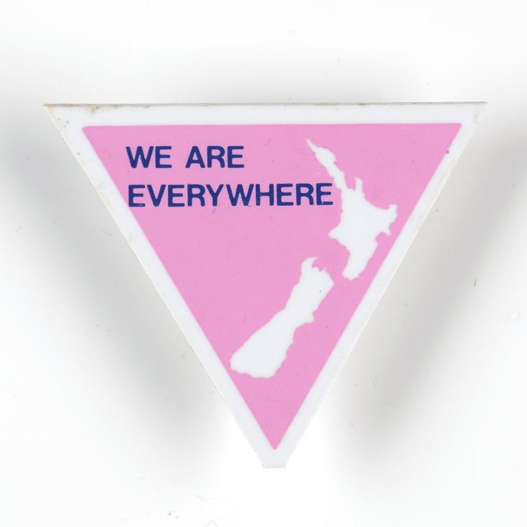 Upside down pink triangle with a white map of New Zealand and the words ‘We are everywhere’