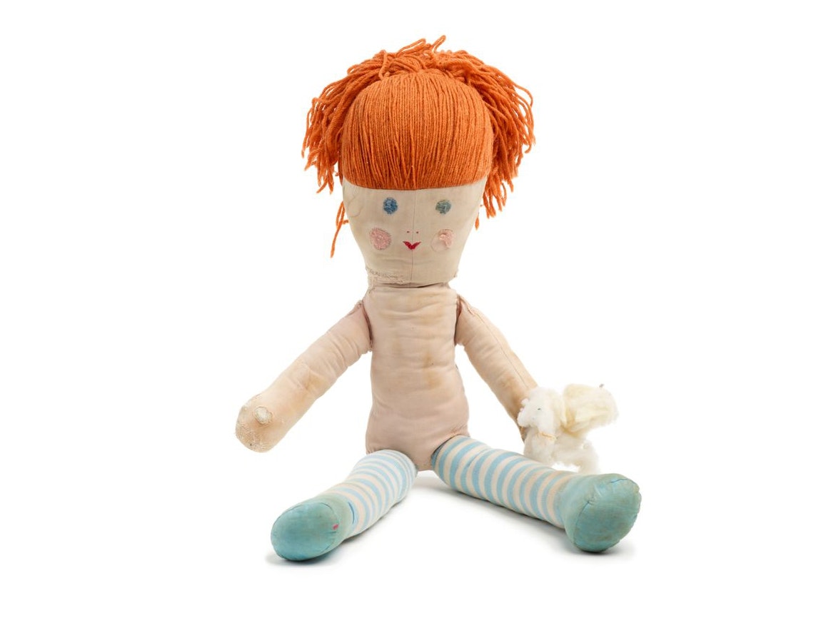 Manu, Unknown; maker/artist; 1968; New Zealand. Gift of the O'Shea family on behalf of Cherie O'Shea, 2007. Te Papa (GH015567) A rag doll with orange hair is sitting on a white background.