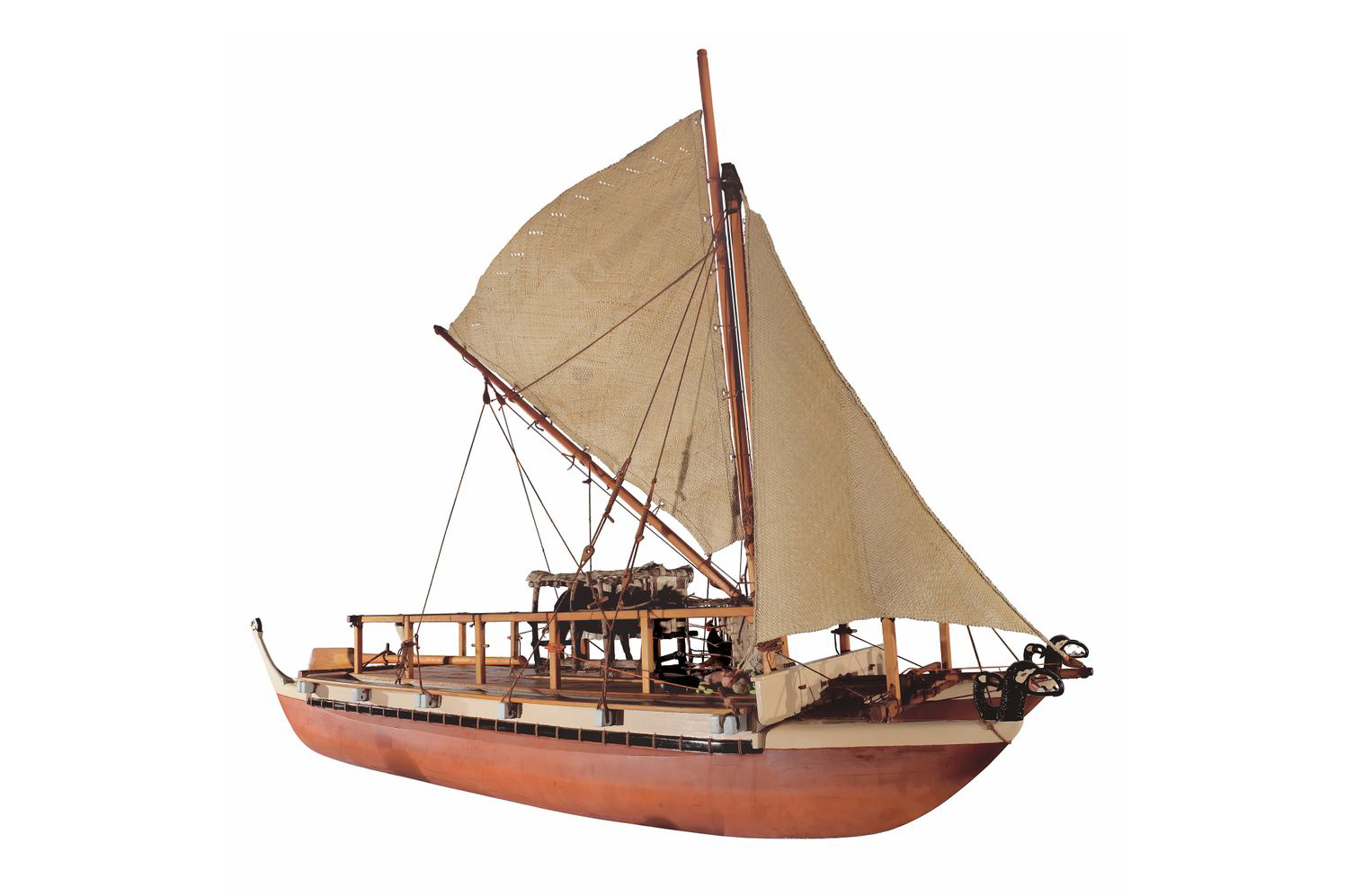 A model double-hulled canoe with a woven sail.