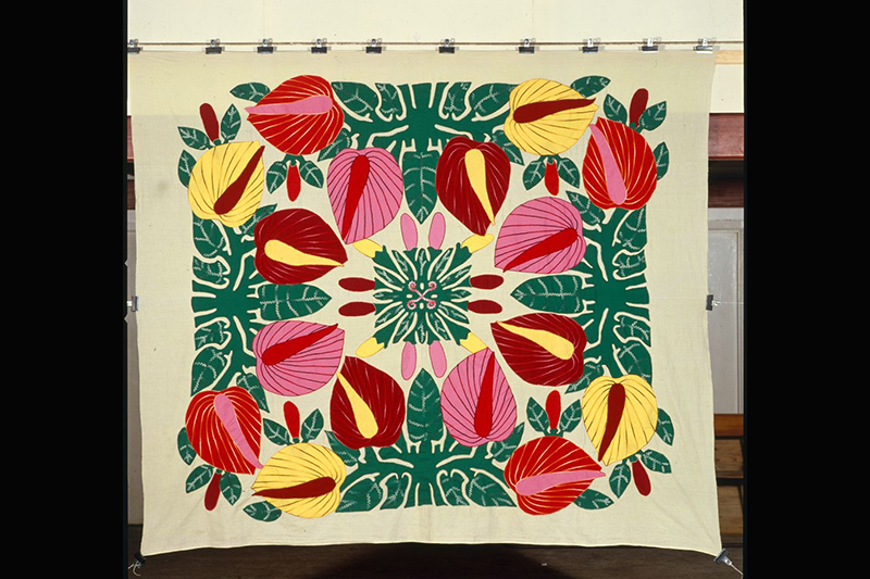 A large piece of material with bright patterns of flowers and leaves.