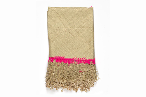 White mat made from pandanus with a pink trim