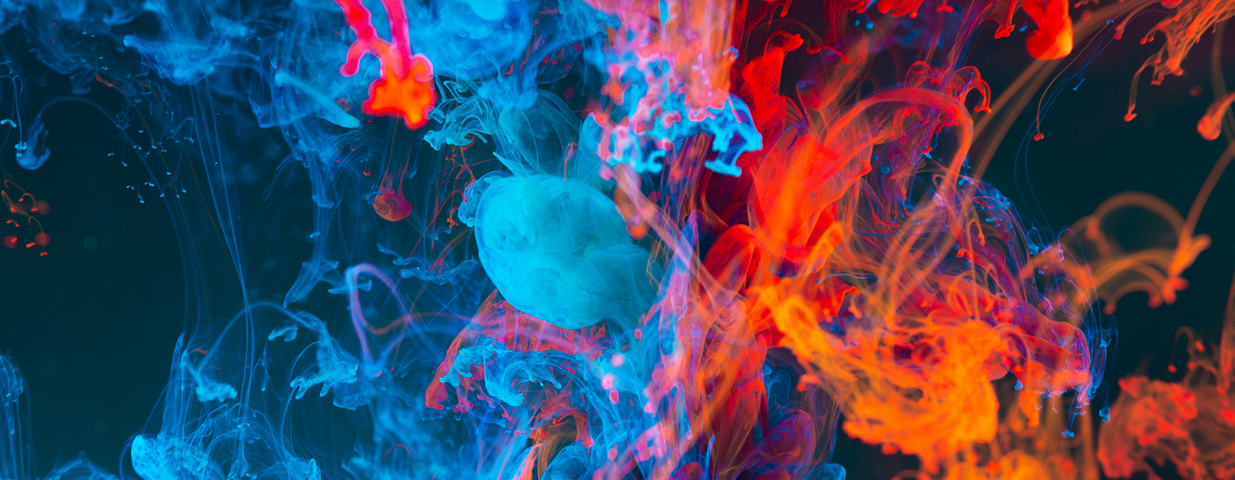 Blue, red, and orange swirly smoke on a black background.