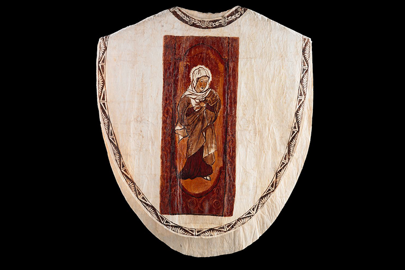 A priest vestment made of tapa with an illustration of Mary on the front.