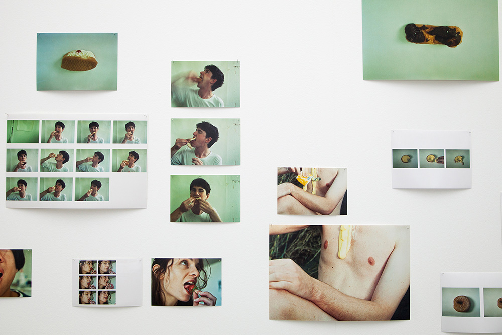 Many photos from the same photo shoot  of people eating suggestively are spread across a white card.