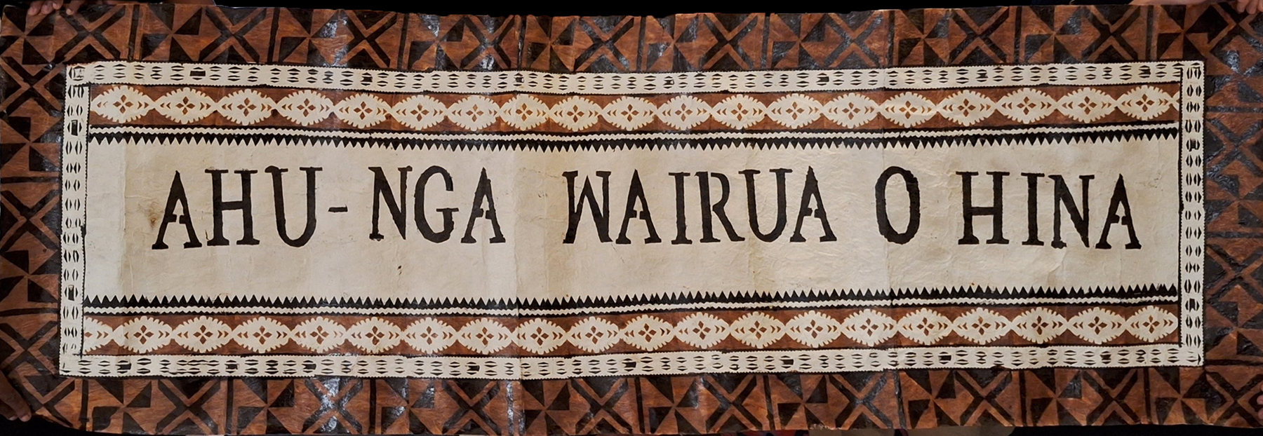 A tapa cloth banner with the words Ahu-nga wairua o hina