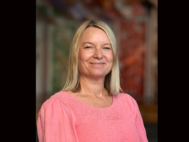 Helen Lloyd. Photo by Yoan Jolly. Te Papa Head and shoulders photo oof a blond woman with a pink dress on