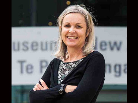 Lee Davidson Photo of a woman with her arms crossed and smiling at the camera