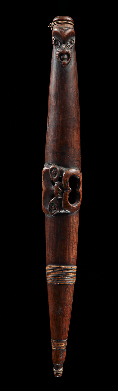 A long piece of wood with hole in each end and in the middle. It is used as a wind instrument.