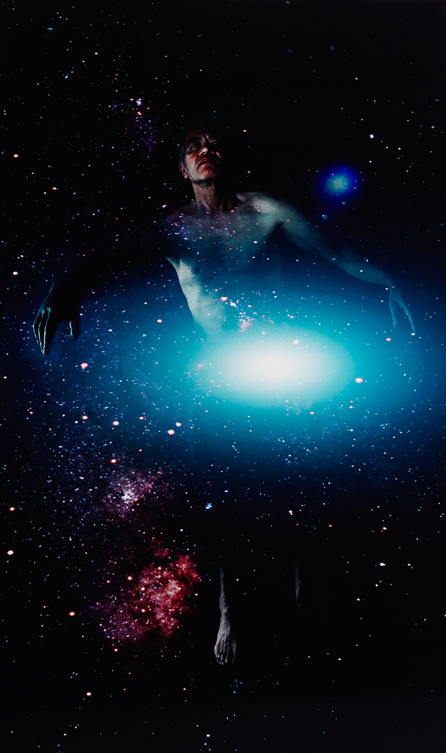 A dramatic photo of a man surrounded by a galaxy and bright star.